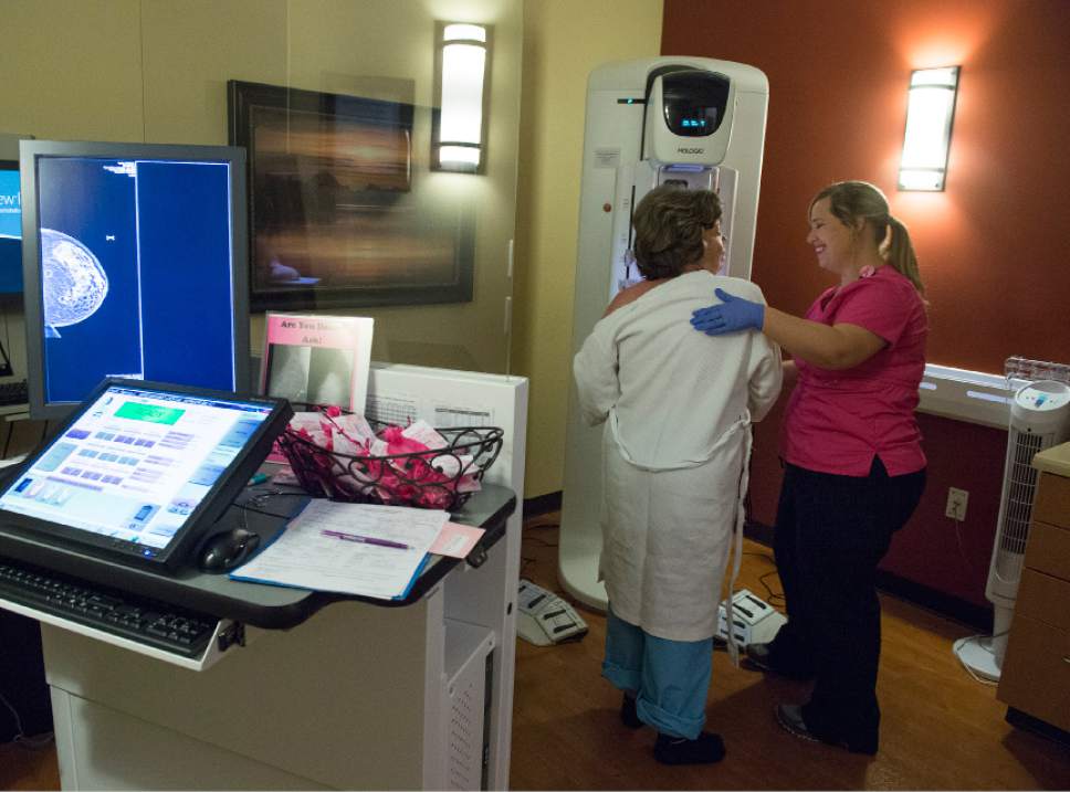 Leah Hogsten  |  The Salt Lake Tribune
l-r Patricia Buck, 63, is assisted by Autumn Mitchell during her annual mammography screening at the Breast Care Center at Davis Hospital, October 4, 2016. Buck says she would like to receive a 3D screening, but her health insurance will only cover 2D mammography screenings. The Genius 3D Hologic Mammography machine provides 2D and 3D imaging. The 3D Mammography exams are a more advanced screening option than conventional 2D mammography, providing crisper, more contrasty images that are proven in clinical studies to detect cancer 15 months earlier than regular mammograms  and reduce unnecessary patient recalls.
