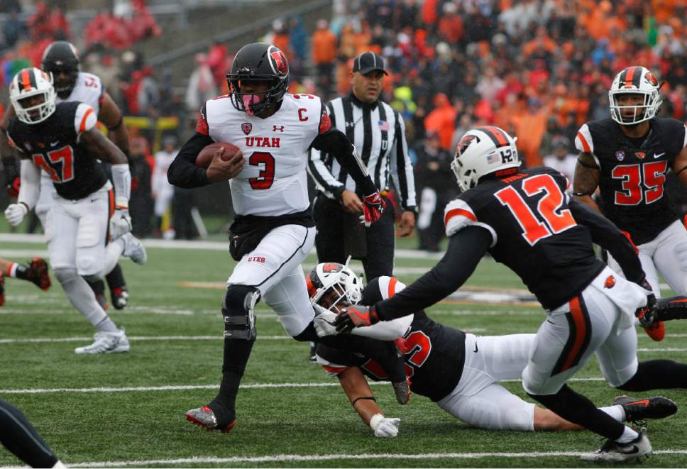 Utah quarterback Troy Williams (3) tries to pull away from Oregon State's Manase Hungalu, bottom, and Kendall Hill (12) in the first half of an NCAA college football game in Corvallis, Ore., on Saturday, Oct. 15, 2016. (AP Photo/Timothy J. Gonzalez)