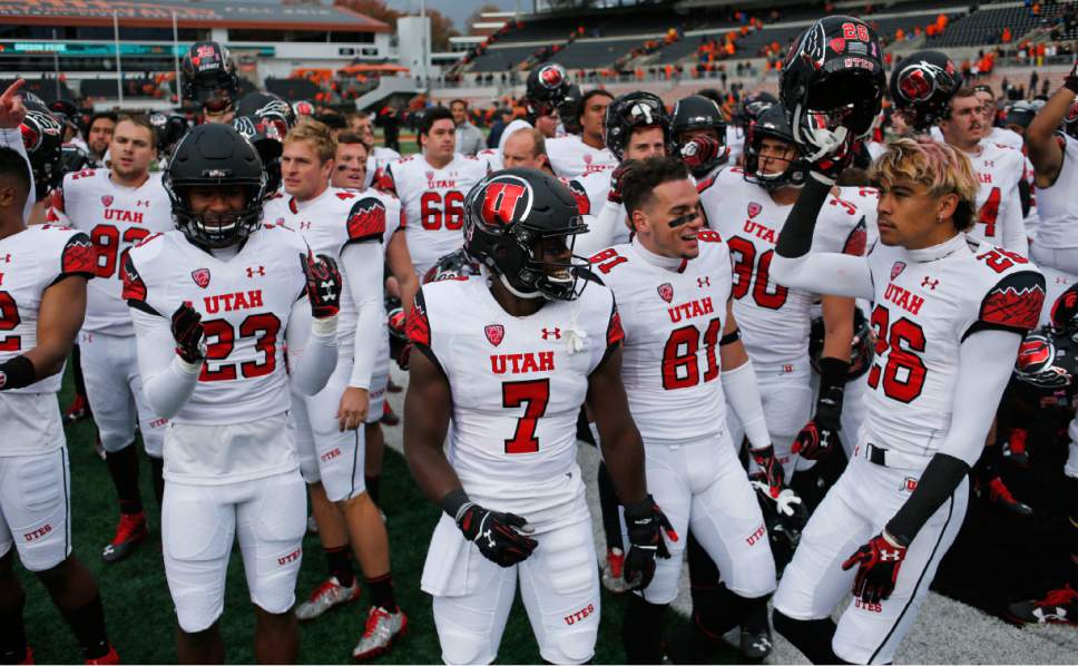 Utah's Julian Blackmon (23), Andre Godfrey (7), Dimitri Salido (81) and Samson Nacua (26) celebrate after Utah's 19-14 victory over Oregon State in an NCAA college football game in Corvallis, Ore., on Saturday, Oct. 15, 2016. (AP Photo/Timothy J. Gonzalez)