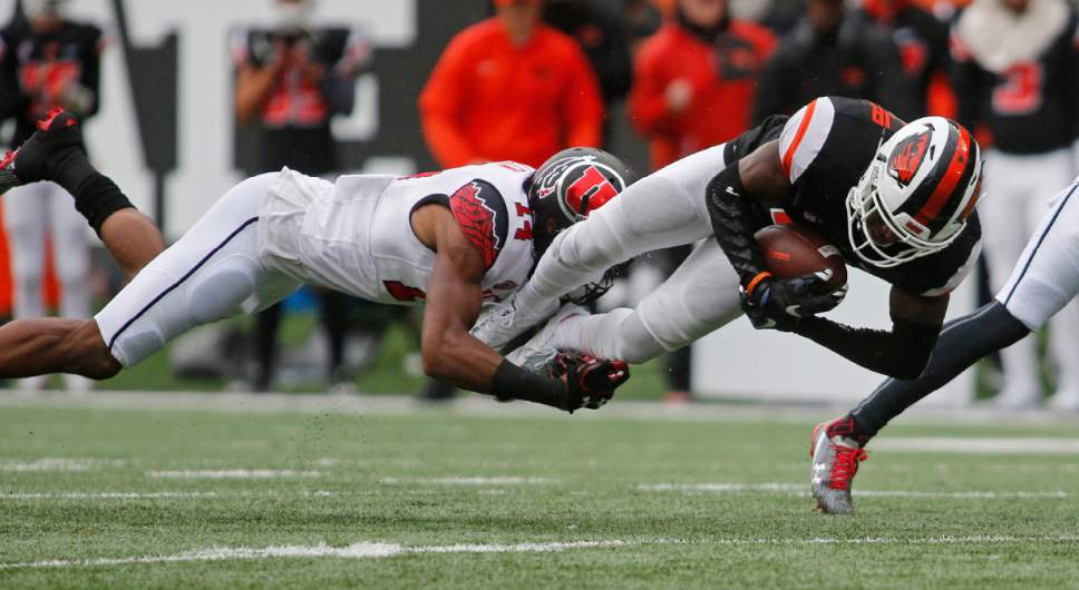 Oregon State wide receiver Victor Bolden Jr., right, is tackled by Utah cornerback Brian Allen in the second half of an NCAA college football game in Corvallis, Ore., on Saturday, Oct. 15, 2016. Utah won 19-14. (AP Photo/Timothy J. Gonzalez)