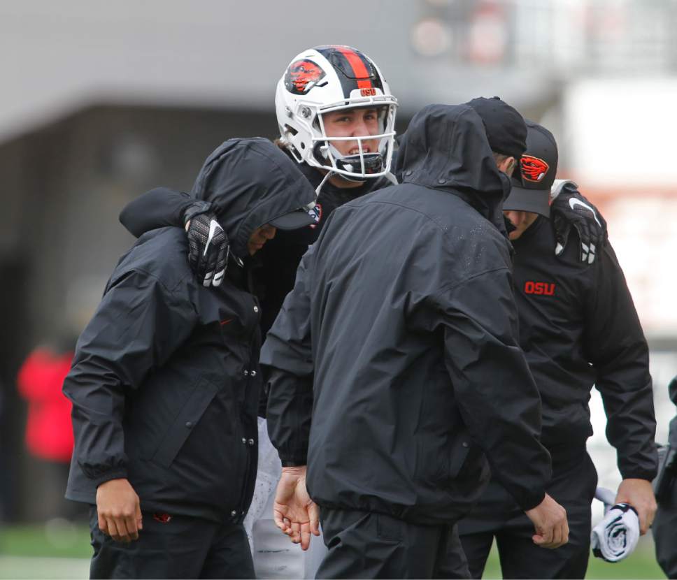 Oregon State starting quarterback Darell Garretson, center, is helped off the field after suffering an injury in the second half of an NCAA college football game against Utah, in Corvallis, Ore., on Saturday, Oct. 15, 2016. Utah won 19-14. (AP Photo/Timothy J. Gonzalez)