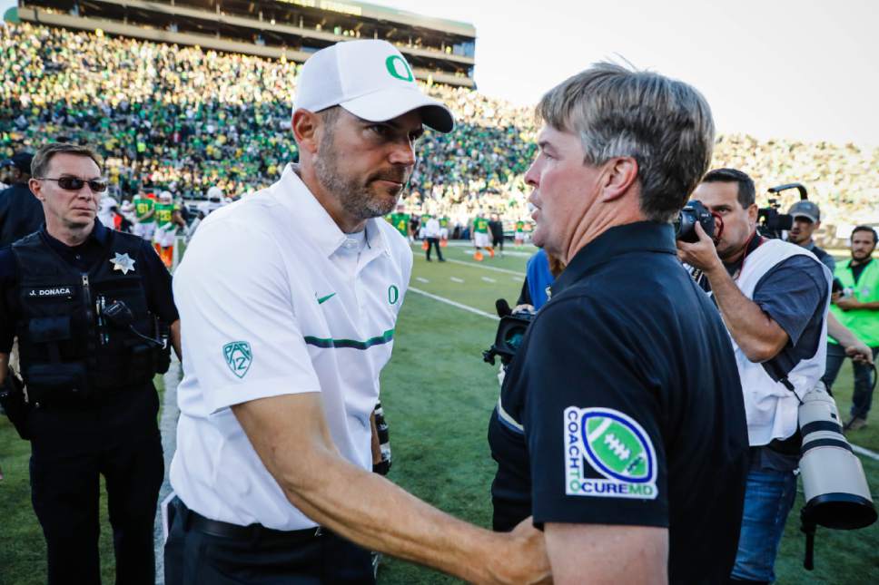 Colorado head coach Mike MacIntyre, right, greets Oregon head coach Mark Helfrich after an NCAA college football game Saturday, Sept. 24, 2016, in Eugene, Ore. Colorado beat Oregon 41-38. (AP Photo/Thomas Boyd)