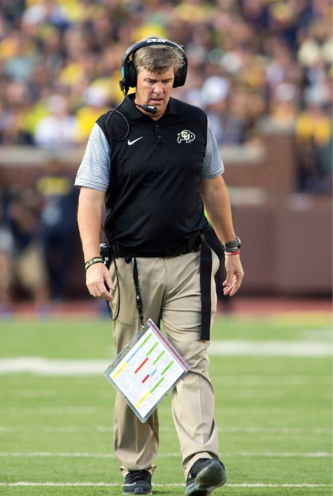 Colorado head coach Mike MacIntyre walks the sideline talking on his headset in the second half of an NCAA college football game against Michigan in Ann Arbor, Mich., Saturday, Sept. 17, 2016. Michigan won 45-28. (AP Photo/Tony Ding)