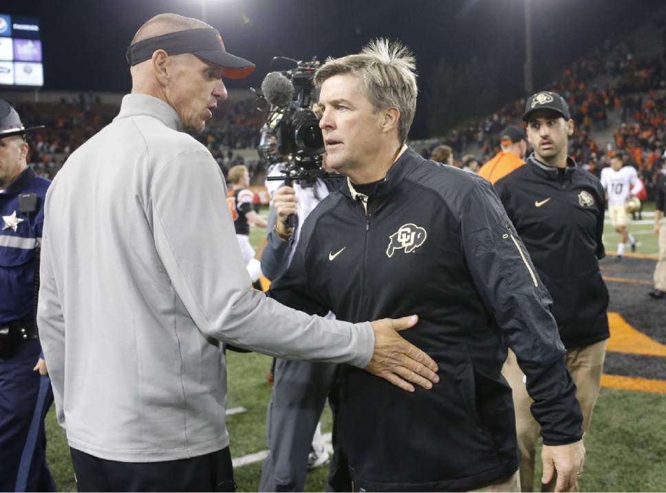 Colorado coach Mike Macintyre, right, is congratulated by Oregon State coach Gary Andersen after Colorado's 17-13 win in an NCAA college football game in Corvallis, Ore., on Saturday, Oct. 24, 2015.(AP Photo/Timothy J. Gonzalez)