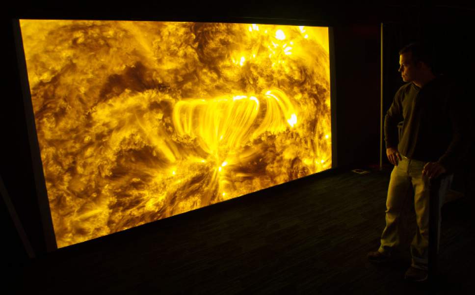 Steve Griffin / The Salt Lake Tribune


Planetarium staff members put the finishing touches on an exhibit that displays activity on the surface of the sun, one of Clark Planetarium's revamped exhibits unveiled Monday, Oct. 17, 2016, in Salt Lake City. The Planetarium is planning a "Ready, Set, Relaunch" party on Saturday.