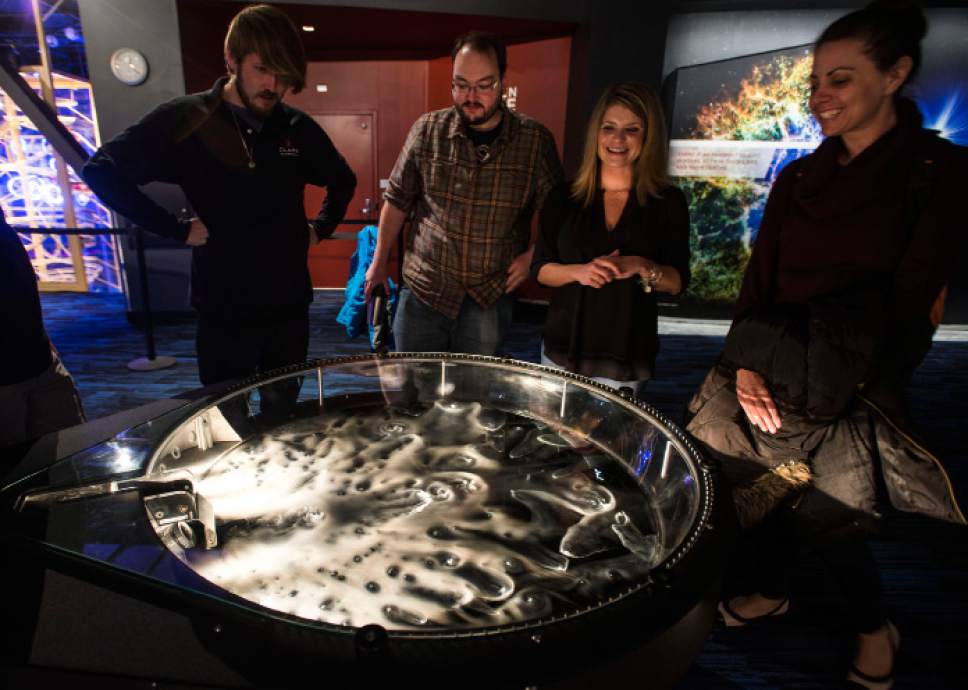 Steve Griffin | The Salt Lake Tribune
Planetarium staff members watch a new exhibit that uses water and dry ice to simulate comets. The exhibit is one Clark Planetarium's revamped exhibits unveiled Monday, Oct. 17, 2016, in Salt Lake City. The Planetarium is planning a ìReady, Set, Relaunchî party on Saturday.