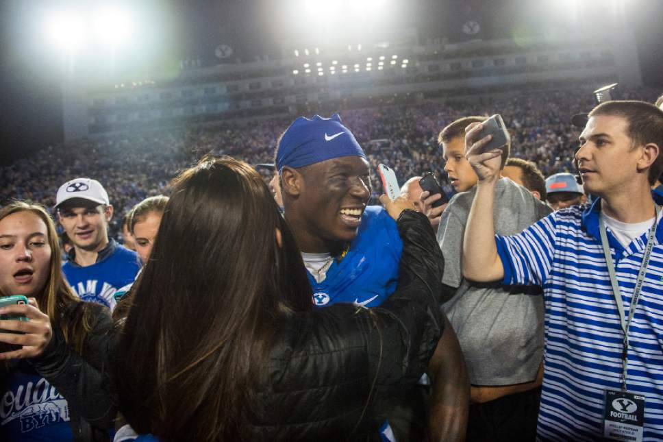 Chris Detrick  |  The Salt Lake Tribune
Brigham Young Cougar fans take selfies and hug Brigham Young Cougars running back Jamaal Williams (21) after the game at LaVell Edwards Stadium Saturday October 15, 2016. Brigham Young Cougars defeated Mississippi State Bulldogs 28-21in double overtime.
