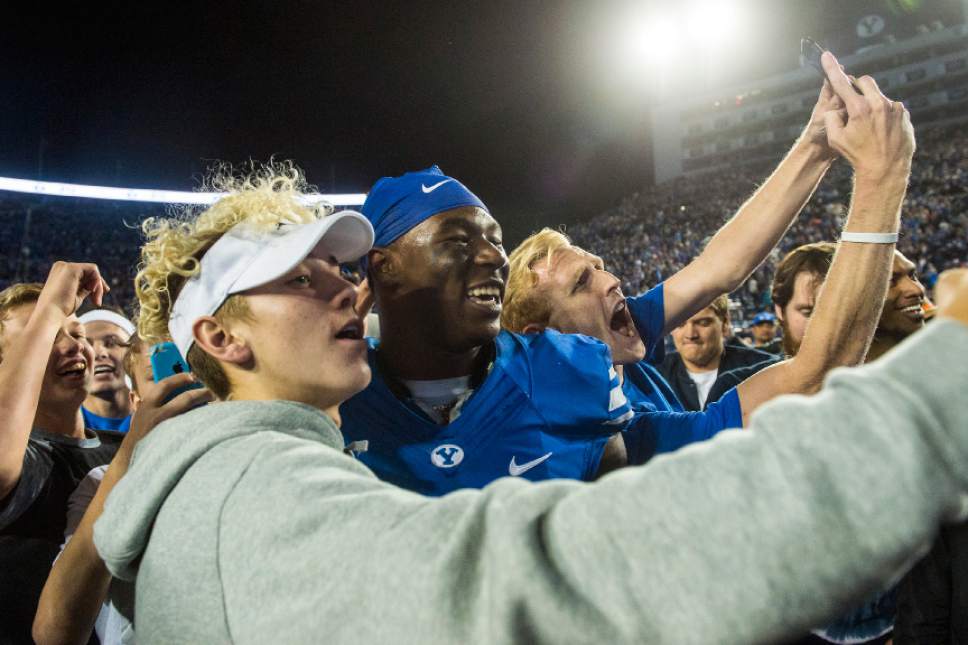 Chris Detrick  |  The Salt Lake Tribune
Brigham Young Cougar fans take selfies with Brigham Young Cougars running back Jamaal Williams (21) after the game at LaVell Edwards Stadium Saturday October 15, 2016. Brigham Young Cougars defeated Mississippi State Bulldogs 28-21in double overtime.