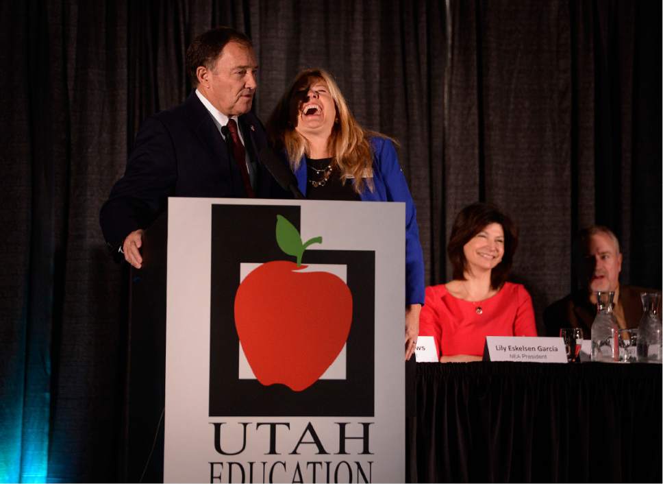 Scott Sommerdorf   |  The Salt Lake Tribune  
UEA President Heidi Matthews laughs as she had to come up to tell Utah Governor Gary Herbert that his allotted time was up as he spoke during the opening of the National Education Association Convention, Thursday, October 20, 2016.