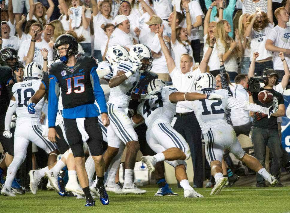 Rick Egan  |  The Salt Lake Tribune

Boise State Broncos quarterback Ryan Finley (15) reacts as Brigham Young Cougars defensive back Kai Nacua (12) celebrates scoring a touchdown on an interception, with just seconds remaining on the clock, in college football action, BYU vs. Boise State at Lavell Edwards Stadium, Saturday, September 12, 2015.