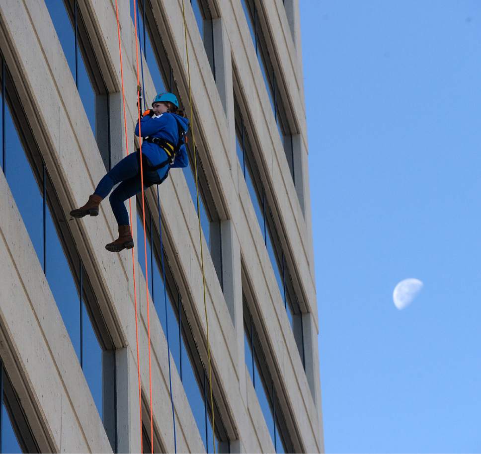 Al Hartmann  |  The Salt Lake Tribune
Heather Edwards rapels from the top of the Maverik Base Camp building in Salt Lake City Friday October 2.  It was her first time rappelling. Up to 90 community members helped victims of domestic violence and sexual assault by going "Over The Edge" of the Maverik Base Camp building. Rappellers will have raised at least $1,000 each in funds for domestic violence and sexual assault services at the Salt Lake Area Family Justice Center at the YWCA.