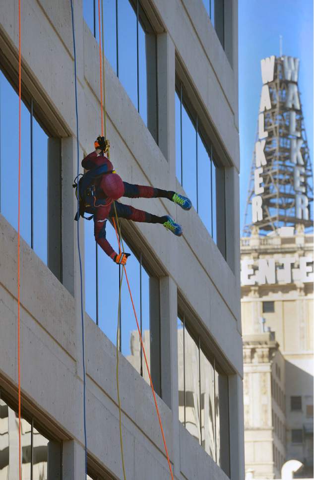 Al Hartmann  |  The Salt Lake Tribune
John Netto dressed as Spiderman but also called "Sliderman" does an unusual sideway rapel from the top of the Maverik Base Camp building in Salt Lake City Friday October 2.  Up to 90 community members helped victims of domestic violence and sexual assault by going "Over The Edge" of the Maverik Base Camp building. Rappellers will have raised at least $1,000 each in funds for domestic violence and sexual assault services at the Salt Lake Area Family Justice Center at the YWCA.
