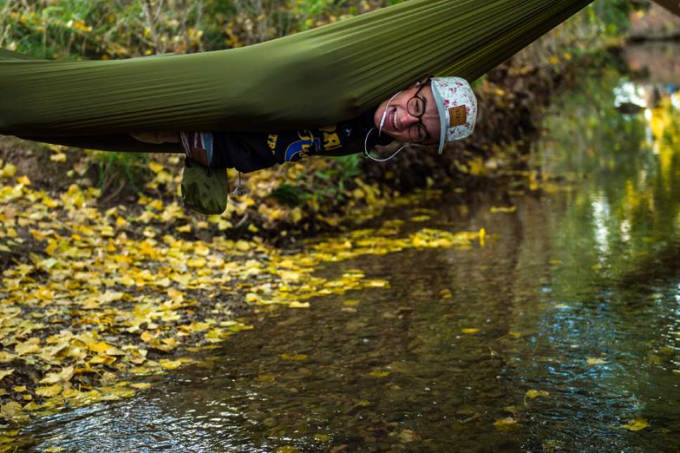 Chris Detrick  |  The Salt Lake Tribune
Orem senior Junior Hallam hangs upside down in a hammock during the UHSAA State Cross Country Championships at Sugar House Park Wednesday October 19, 2016.