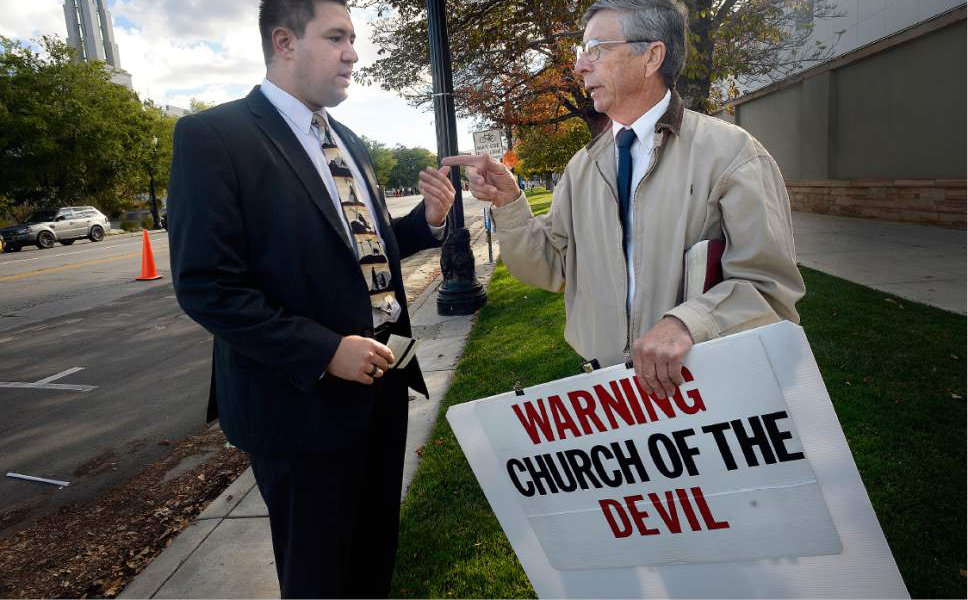 Scott Sommerdorf   |  The Salt Lake Tribune  
Marc Hallicker, left, on his way to attend Conference, stopped to talk with "Preacher Carl" who stationed himself at the corner of North Temple and West Temple, October 1, 2016.