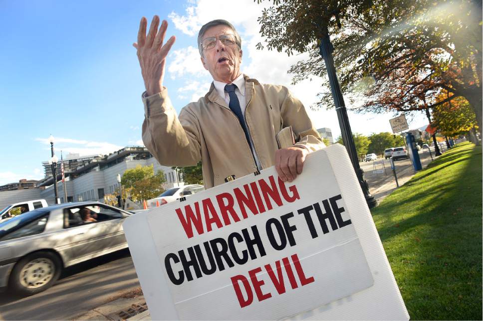 Scott Sommerdorf   |  The Salt Lake Tribune  
"Preacher Carl" keeps a running discourse going as people queue up to cross North Temple on their way to attend Conference, October 1, 2016.
