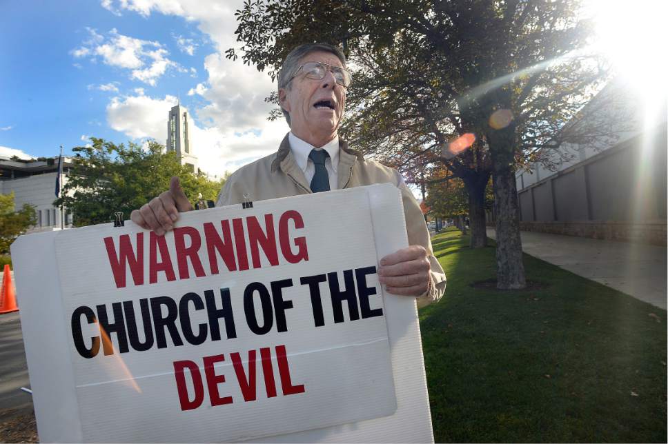 Scott Sommerdorf   |  The Salt Lake Tribune  
"Preacher Carl" keeps a running discourse going as people queue up to cross North Temple on their way to attend Conference, October 1, 2016.