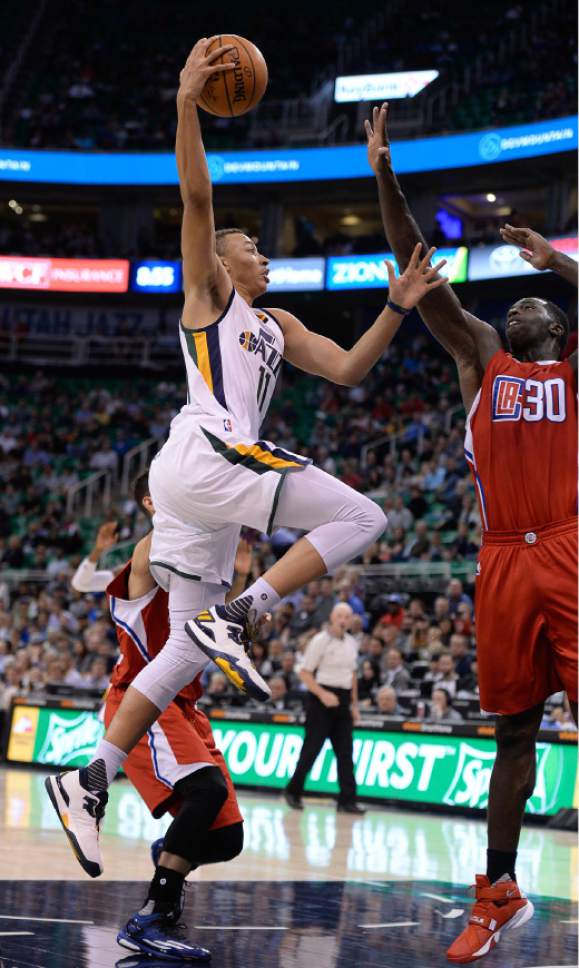 Francisco Kjolseth | The Salt Lake Tribune
Utah Jazz guard Dante Exum (11) reaches high over Los Angeles Clippers forward Brandon Bass (30) in game action at Vivint Smart Home Arena on Monday, Oct. 17, 2016, with a Jazz win of 104-78.