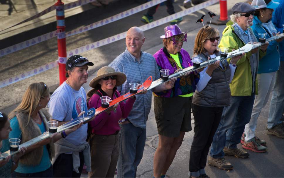 Leah Hogsten  |  The Salt Lake Tribune
Wasatch Brew Pub in Park City celebrated its 30th anniversary by attempting to break the world "shot-ski" record, Saturday, October 22, 2016. For the attempt, 1,191 people lined up on Main Street to raise one long ski -- 1,961-feet long with glasses attached-- for a shot of Wastach's premium ale.