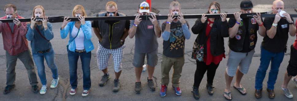 Leah Hogsten  |  The Salt Lake Tribune
Revelers raise the ski to take the shot. Wasatch Brew Pub in Park City celebrated its 30th anniversary by attempting to break the world "shot-ski" record, Saturday, October 22, 2016. For the attempt, 1,191 people lined up on Main Street to raise one long ski -- 1,961-feet long with glasses attached-- for a shot of Wastach's premium ale.