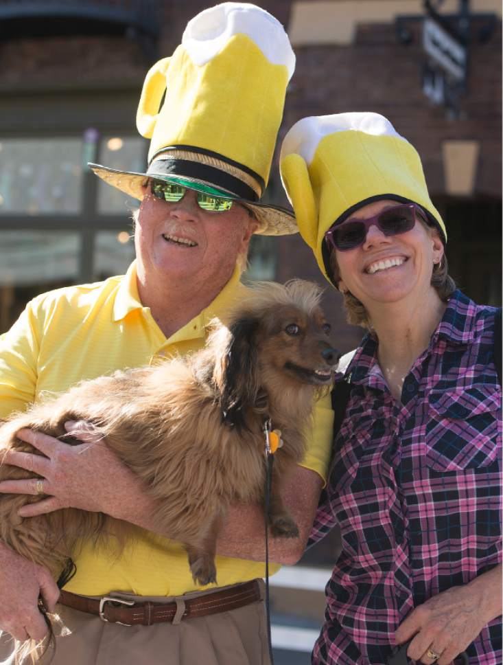 Leah Hogsten  |  The Salt Lake Tribune
Brad and Lou Rounds brought their dog Luka and their beer hats. Wasatch Brew Pub in Park City celebrated its 30th anniversary by attempting to break the world "shot-ski" record, Saturday, October 22, 2016. For the attempt, 1,191 people lined up on Main Street to raise one long ski -- 1,961-feet long with glasses attached-- for a shot of Wastach's premium ale.