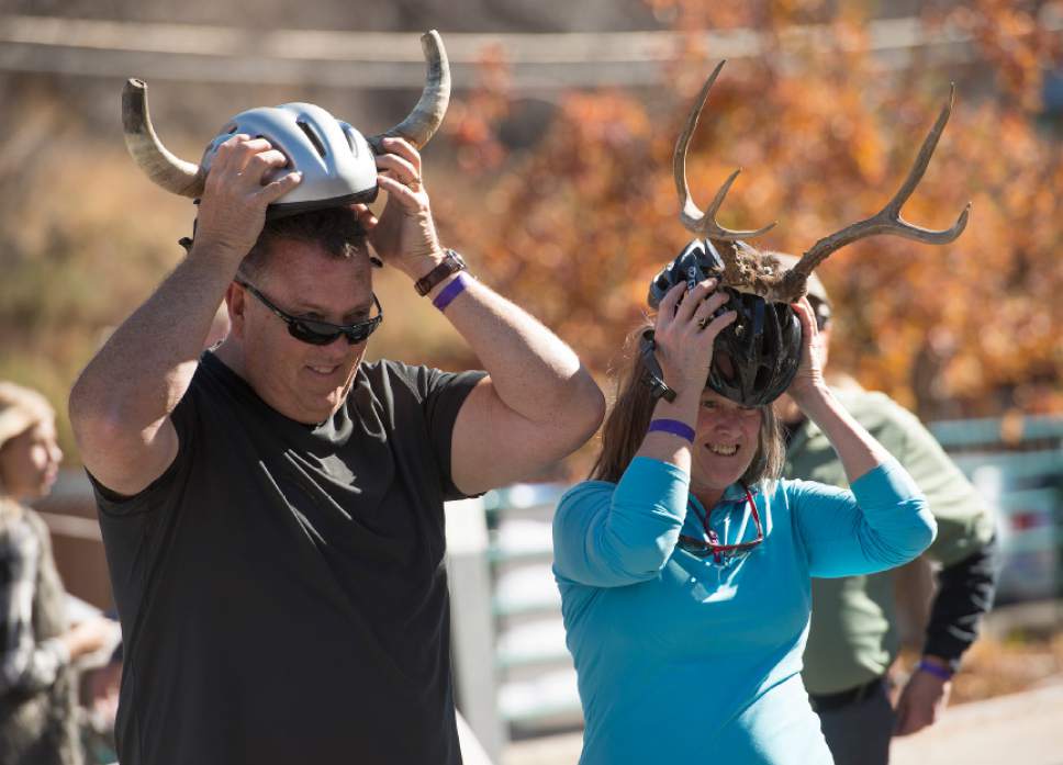 Leah Hogsten  |  The Salt Lake Tribune
l-r Brett Nickelsen and Mona Cotter wore helmets during the shot-ski event. Wasatch Brew Pub in Park City celebrated its 30th anniversary by attempting to break the world "shot-ski" record, Saturday, October 22, 2016. For the attempt, 1,191 people lined up on Main Street to raise one long ski -- 1,961-feet long with glasses attached-- for a shot of Wastach's premium ale.