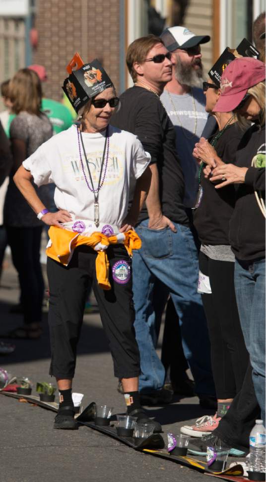 Leah Hogsten  |  The Salt Lake Tribune
Nancy Detamble wore a six-pack box atop her head. Wasatch Brew Pub in Park City celebrated its 30th anniversary by attempting to break the world "shot-ski" record, Saturday, October 22, 2016. For the attempt, 1,191 people lined up on Main Street to raise one long ski -- 1,961-feet long with glasses attached-- for a shot of Wastach's premium ale.