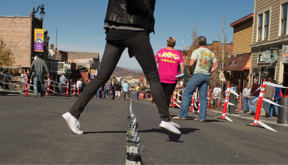 Leah Hogsten  |  The Salt Lake Tribune
Wasatch Brew Pub in Park City celebrated its 30th anniversary by attempting to break the world "shot-ski" record, Saturday, October 22, 2016. For the attempt, 1,191 people lined up on Main Street to raise one long ski -- 1,961-feet long with glasses attached-- for a shot of Wastach's premium ale.