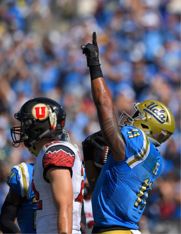 UCLA tight end Nate Iese, right, celebrates his touchdown as Utah defensive back Chase Hansen walks away during the first half of an NCAA college football game, Saturday, Oct. 22, 2016, in Pasadena, Calif. (AP Photo/Mark J. Terrill)