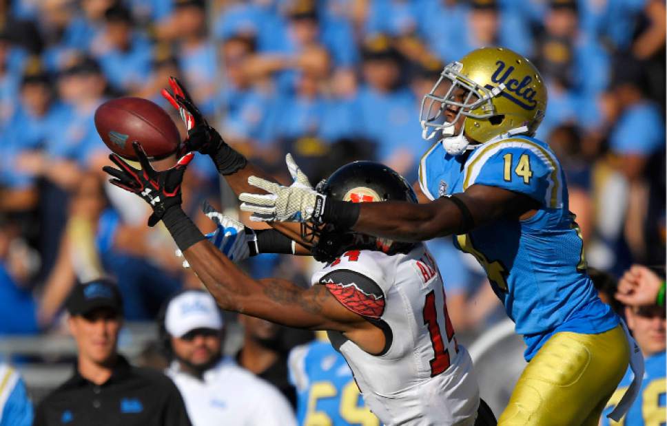 Utah defensive back Brian Allen, left, intercepts a pass intended for UCLA wide receiver Theo Howard during the second half of an NCAA college football game, Saturday, Oct. 22, 2016, in Pasadena, Calif. Utah won 52-45. (AP Photo/Mark J. Terrill)