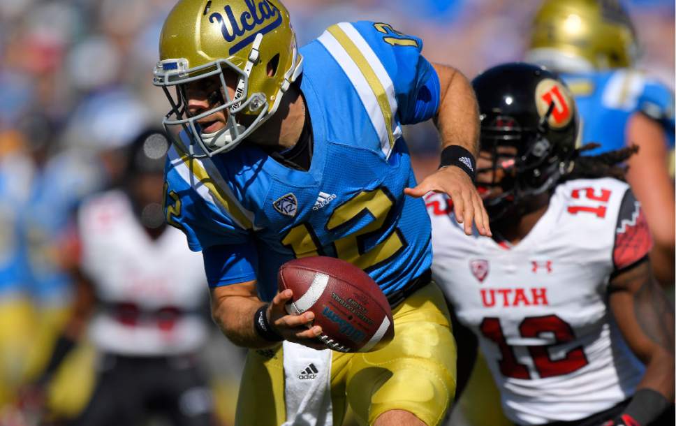 UCLA quarterback Mike Fafaul, left, tries to get away from Utah defensive back Justin Thomas during the first half of an NCAA college football game, Saturday, Oct. 22, 2016, in Pasadena, Calif. (AP Photo/Mark J. Terrill)