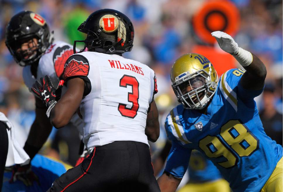 UCLA defensive lineman Takkarist McKinley, right, gets ready to sack Utah quarterback Troy Williams during the first half of an NCAA college football game, Saturday, Oct. 22, 2016, in Pasadena, Calif. McKinley also stripped the ball from Williams on the play. (AP Photo/Mark J. Terrill)