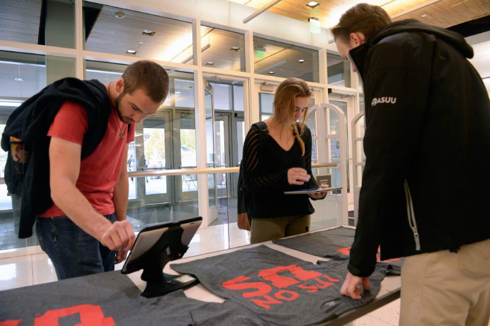 Al Hartmann  |  The Salt Lake Tribune
University of Utah students Greyson Harnes and Shelby Waymont sign the "It's on Us" pledge in support for sexual assault victims.  They also received a T-shirt.  
The university conducted a campus climate survey, and most students say they have no idea where to report assaults.
