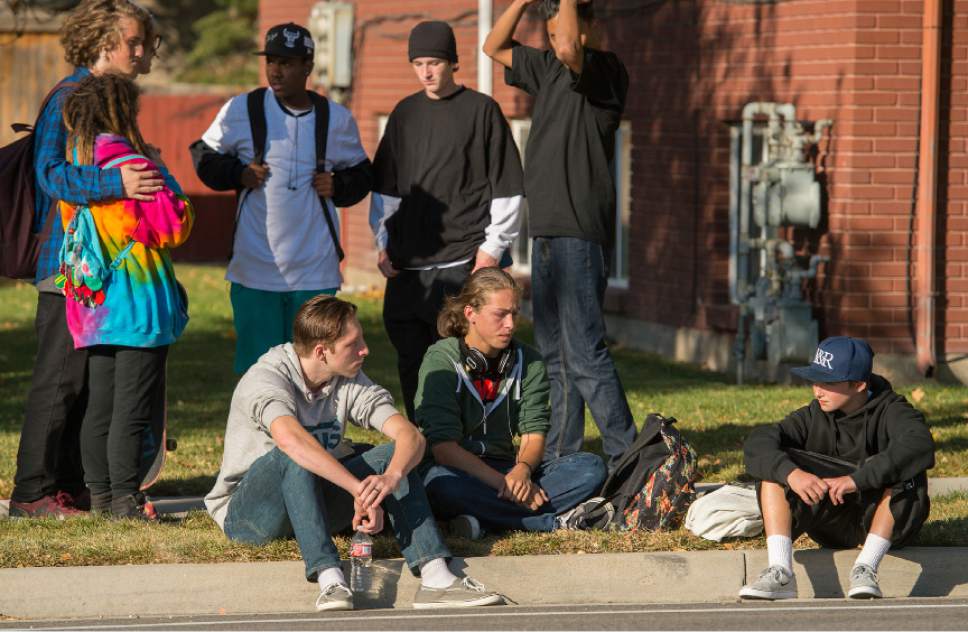 Leah Hogsten  |  The Salt Lake Tribune
Kalani Matthews, 17, center, and friends watch the police scene across the street at Union Middle School. A 16-year-old boy was critically injured after being shot outside Union Middle School in Sandy by a 14-year-old, who is a student at the middle school. The shooting occurred about 3 p.m. when two teenage boys got into an argument on a field north of the school, said Sandy police Sgt. Dean Carriger. The victim -- who is a student at Hillcrest High School -- was transported by ambulance in critical condition to Intermountain Medical Center, where he went into surgery about 4:30 p.m. to treat two gunshot wounds. The 14-year-old suspect is in custody.