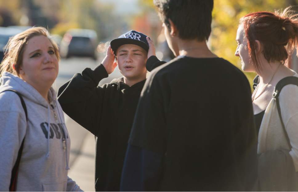 Leah Hogsten  |  The Salt Lake Tribune
"He's alive?" cried Mason Lewis, 14, with his hands on his head, after Dusti Rowland, left, and Rachel Otteson, 18, right, told him that a teen was recovering after surgery. Lewis said he ate lunch with the victim at Hillcrest High School hours before the shooting occurred. A 16-year-old boy was critically injured after being shot outside Union Middle School in Sandy by a 14-year-old, who is a student at the middle school.The shooting occurred about 3 p.m. when two teenage boys got into an argument on a field north of the school, said Sandy police Sgt. Dean Carriger. The victim ó who is a student at Hillcrest High School ó was transported by ambulance in critical condition to Intermountain Medical Center, where he went into surgery about 4:30 p.m. to treat two gunshot wounds. The 14-year-old suspect is in custody.