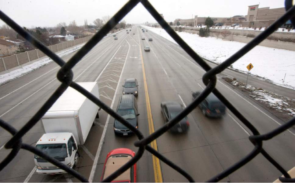 Al Hartmann  |  Tribune file photo
A pedestrian's view looking south out the chain link fence from the walkway over Bangerter Highway at 70th South. Jordan Landing shopping center, right, runs for the next eight blocks with another of the walkways at 7800 S. and Bangerter. The 2 walkways are the only safe ways across Bangerter for 8 blocks for a pedestrian.