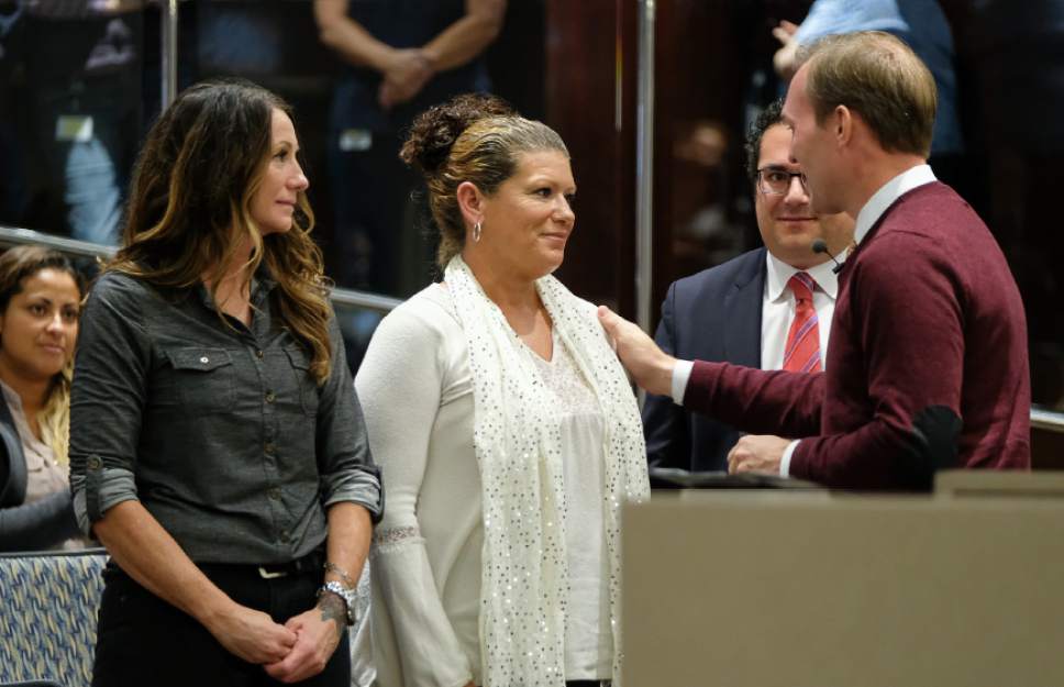 Francisco Kjolseth | The Salt Lake Tribune
Salt Lake County Mayor Ben McAdams acknowledges Barbara Pierce, center, a client of Odyssey House who overcame an opioid addiction following a back surgery that eventually left her homeless. Following treatment she is working to get her life back together. Also acknowledged by McAdams during 2017 budget presentation to the County Council was  Sheryl Chivers, Program Director of Odyssey House, left, and Executive Director Adam Cohen.