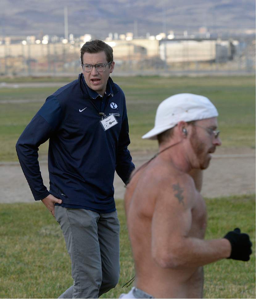 Al Hartmann  |  The Salt Lake Tribune
Isaac Wood, BYU's director of track and field operations, has been teaching a running clinic for inmates for the past two years.  He shouts out encouragement and pacing instructions to runners at the Draper Invitational Marathon, Half-Marathon and 10K races Tuesday morning October 25.
