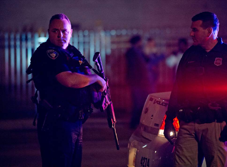 Lennie Mahler  |  The Salt Lake Tribune

A University of Utah police officer holds an assault rifle while responding to a crowd that formed after an officer-involved shooting at 200 South Rio Grande Street in Salt Lake City, Saturday, Feb. 27, 2016.