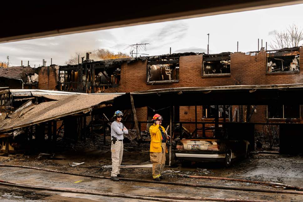 Trent Nelson  |  The Salt Lake Tribune
Fire crews survey the scene after an early morning two-alarm fire raced through much of a Murray condominium-townhome complex, causing no injuries but leaving about 20 residents homeless on Friday.