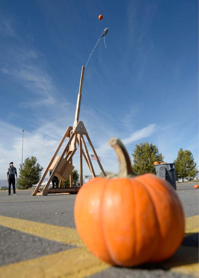 Al Hartmann  |  The Salt Lake Tribune
K-Bull 93's radio station presented their first ever "pumpkin fling" using a trebuchet siege engine used in the Middle Ages. Contestants dressed in Halloween costumes picked the right sized pumpkin loaded them onto the  giant pumpkin tosser and pulled a rope to launch them 100 feet to try and hit a K-Bull van in the parking lot of the South Town Mall in Sandy. The winner gots VIP suite tickets to Carrie Underwood's concert, November 28th at the Maverik Center.