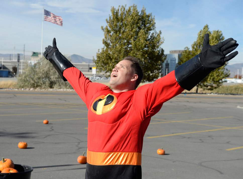 Al Hartmann  |  The Salt Lake Tribune
K-Bull 93's radio station presented their first ever "pumpkin fling" using a trebuchet siege engine like those used in the Middle Ages. Super hero Brian Larson celebrates a direct hit to the K-Bull van 100 feet away in the parking lot of the South Town Mall in Sandy. He won VIP suite tickets to Carrie Underwood's concert, November 28th at the Maverik Center which he said would make his wife very happy.