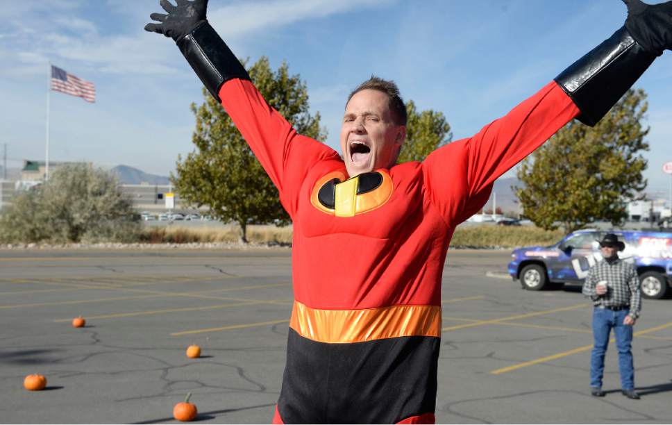 Al Hartmann  |  The Salt Lake Tribune
K-Bull 93's radio station presented their first ever "pumpkin fling" using a trebuchet siege engine like those used in the Middle Ages.  Super hero Brian Larson celebrates a direct hit to the K-Bull van 100 feet away in the parking lot of the South Town Mall in Sandy.   He won VIP suite tickets to Carrie Underwood's concert, November 28th at the Maverik Center which he said would make his wife very happy.