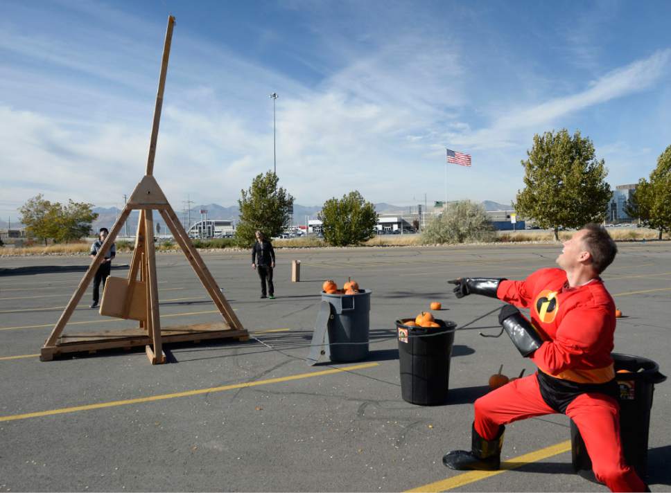Al Hartmann  |  The Salt Lake Tribune
K-Bull 93's radio station presented their first ever "pumpkin fling" using a trebuchet siege engine like those used in the Middle Ages.  Brian Larson uses his super hero strength and style to launch his pumpkin from the pumpkin tosser to hit a K-Bull van 100 feet away in the parking lot of the South Town Mall in Sandy.  He was the only contestant to make a direct hit.  He won VIP suite tickets to Carrie Underwood's concert, November 28th at the Maverik Center which he said would make his wife very happy.