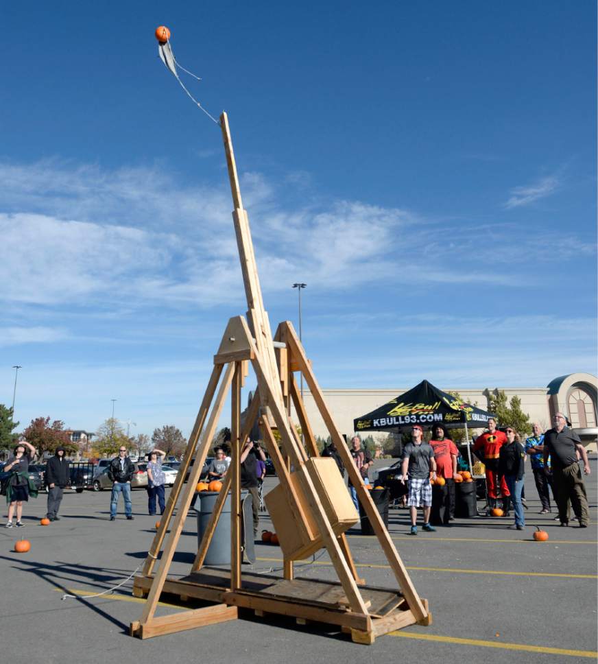Al Hartmann  |  The Salt Lake Tribune
K-Bull 93's radio station presented their first ever "pumpkin fling" using a trebuchet siege engine used in the Middle Ages. Contestants dressed in Halloween costumes picked the right sized pumpkin loaded them onto the  giant pumpkin tosser and pulled a rope to launch them 100 feet to try and hit a K-Bull van in the parking lot of the South Town Mall in Sandy.  The winner gots VIP suite tickets to Carrie Underwood's concert, November 28th at the Maverik Center.
