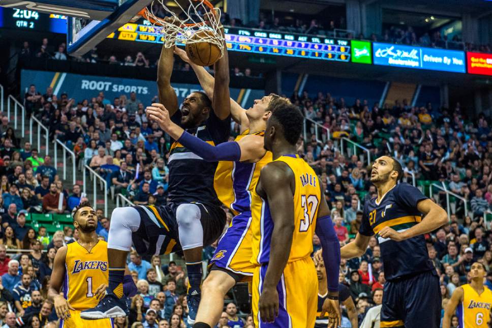 Chris Detrick  |  The Salt Lake Tribune
Utah Jazz forward Derrick Favors (15) dunks past Los Angeles Lakers center Timofey Mozgov (20) and Los Angeles Lakers forward Julius Randle (30) during the game at Vivint Smart Home Arena Friday October 28, 2016.