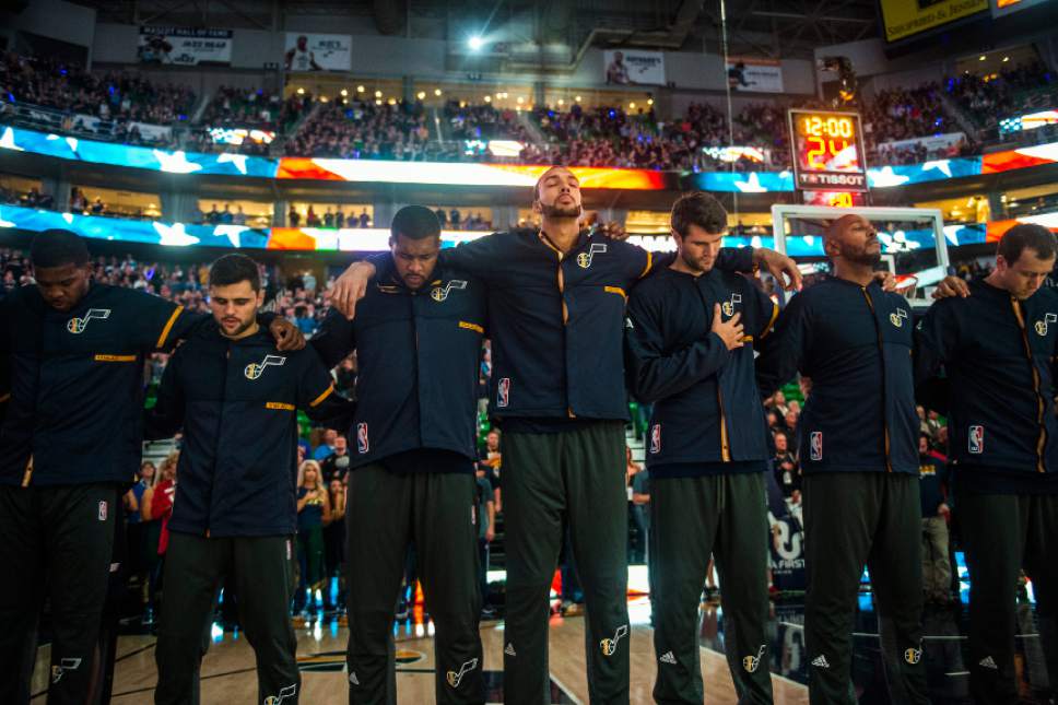 Chris Detrick  |  The Salt Lake Tribune
Members of the Utah Jazz put their arms around each other during the National Anthem before the game at Vivint Smart Home Arena Friday October 28, 2016.