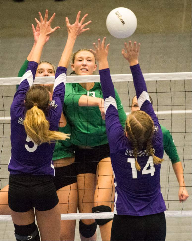 Rick Egan  |  The Salt Lake Tribune 

South Summit Wild Cats Samantha Rogers (13) hits the ball over North Summitt Braves defenders, Hunter Vernon (5) and Megan Richins (14), in the 2A Volleyball State game, Saturday, October 29, 2016.