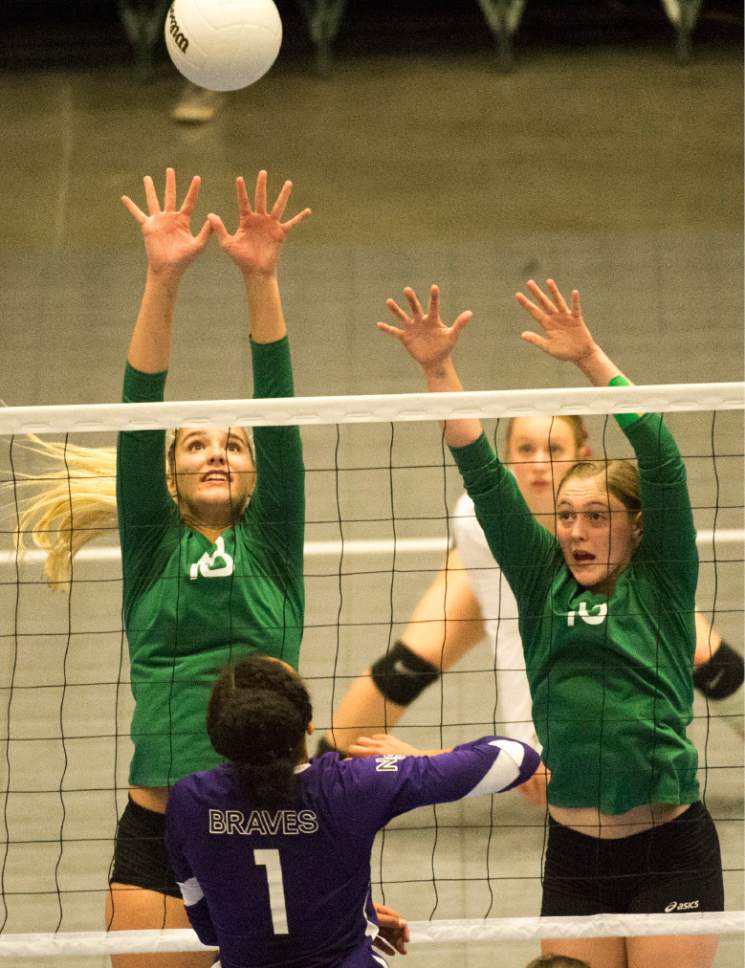 Rick Egan  |  The Salt Lake Tribune 

North  Summit Wild Cats Ashlin Blonquist   (1) hits the ball over South Summitt Braves defenders, Elise Bush (18) and Cassidy Hortin (16), in the 2A Volleyball State game, Saturday, October 29, 2016.