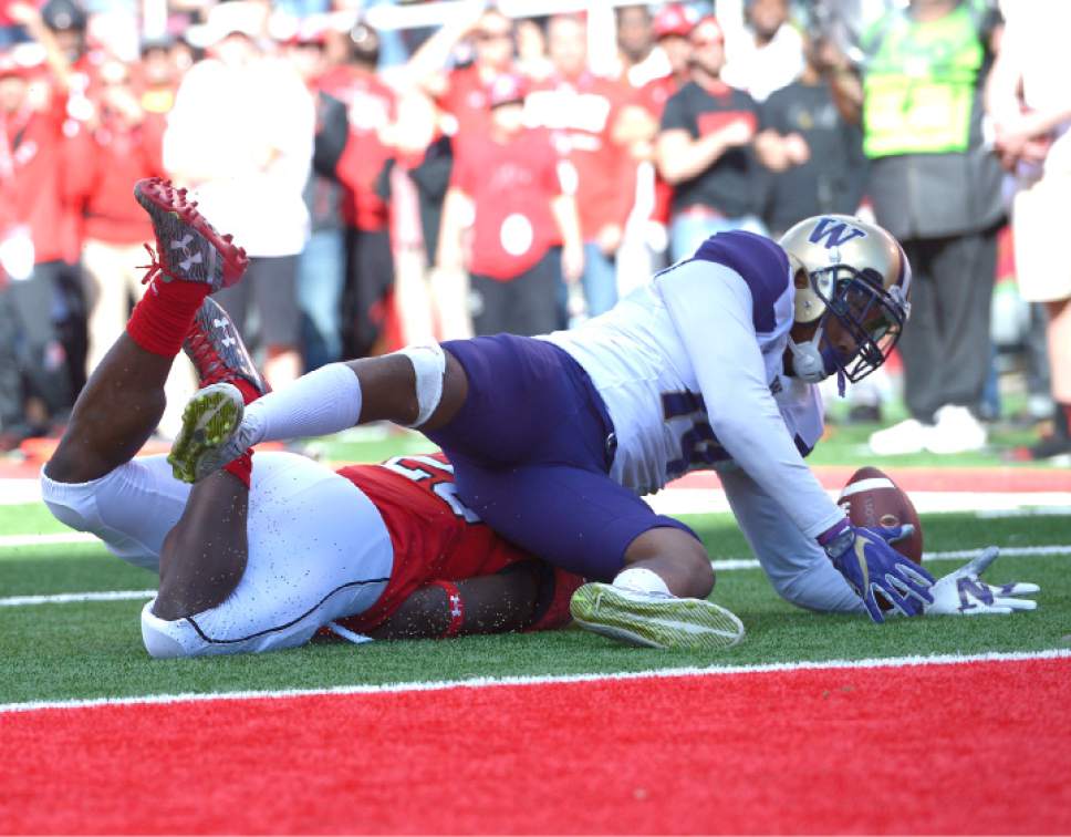 Leah Hogsten  |  The Salt Lake Tribune
Utah Utes running back Joe Williams (28) drops the ball, recovered by Washington Huskies defensive back Jojo McIntosh (14), but no fumble on the play.  University of Washington Huskies lead University of Utah Utes 14-10 during the first half of their game at Rice-Eccles Stadium, Saturday, October 29, 2016.