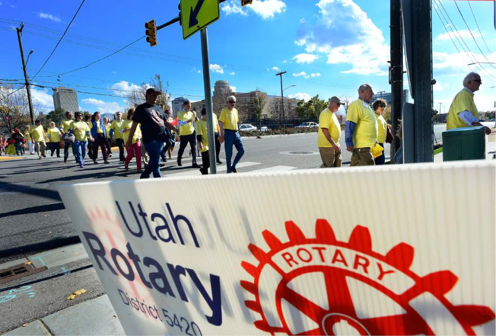 Scott Sommerdorf   |  The Salt Lake Tribune  
A procession of Rotary members crosses 300 West on their way to the Utah Rotary Club's and Rotary Youth Program's conference on refugee services at West High School on Saturday.